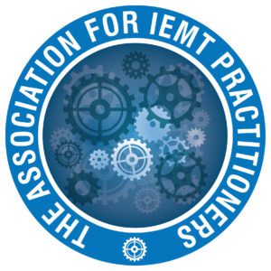 Logo for The Association for IEMT Practitioners, featuring overlapping blue gears in the centre—symbolising support for trauma and PTSD—surrounded by a blue circular border with the organisation’s name in white capital letters.