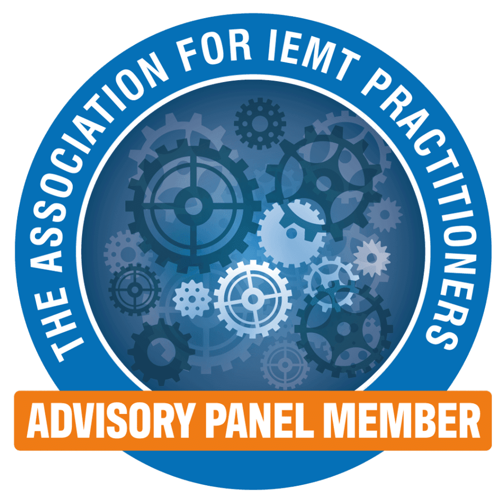 Circular blue badge with gears in the centre, surrounded by the text The Association for IEMT Practitioners. An orange...