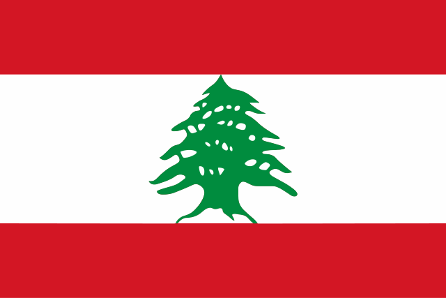 The image shows the national flag of Lebanon, featuring two horizontal red stripes at the top and bottom, a white stripe...