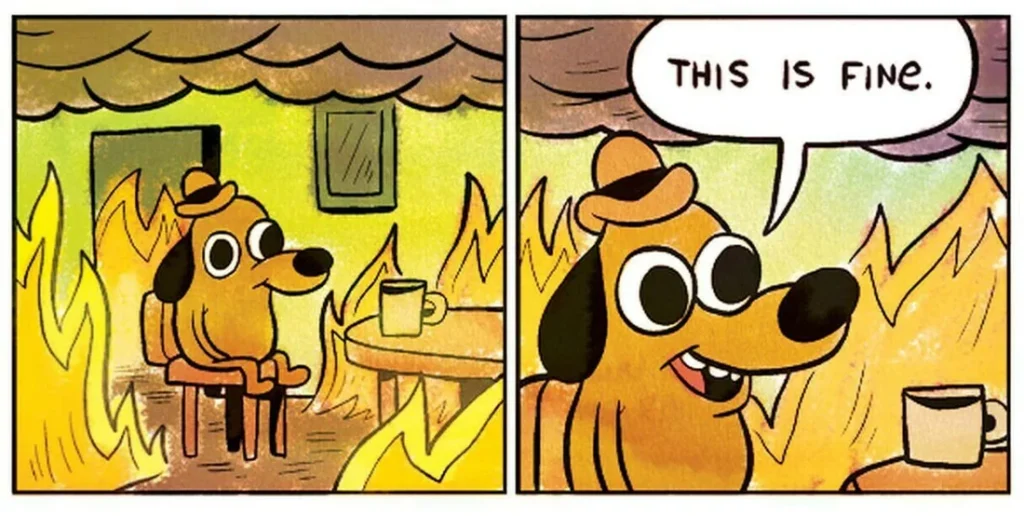 A cartoon dog sits calmly at a table with a mug, surrounded by flames, saying This is fine—an ironic nod to how PTSD or...
