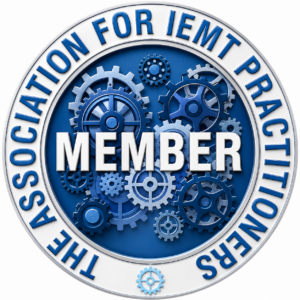 A circular blue and white badge with gears in the centre and the word MEMBER over them. Around the edge, it reads: THE ASSOCIATION FOR IEMT PRACTITIONERS.